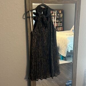 Fun and flouncy dress! Bow neckline and stunning sequins throughout.